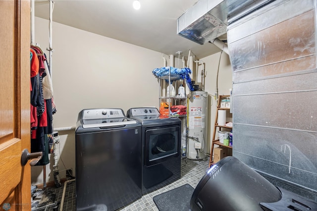 laundry room featuring washing machine and dryer, gas water heater, and laundry area