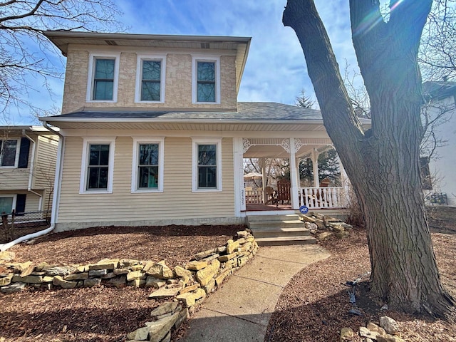 view of front of house featuring roof with shingles and covered porch