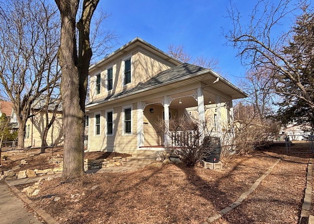 view of front of house featuring a porch and fence