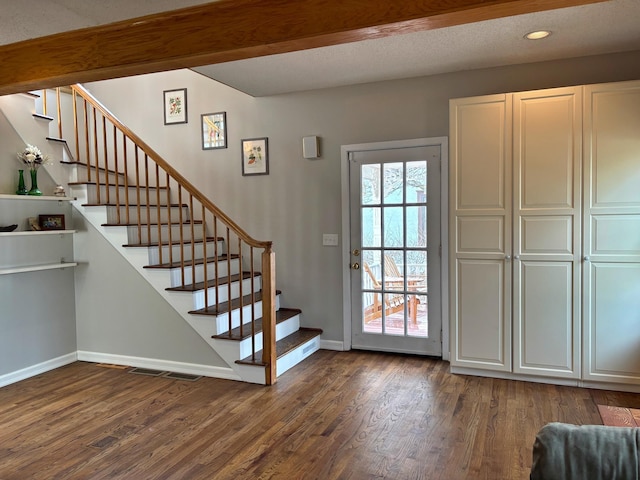 entryway featuring visible vents, baseboards, dark wood finished floors, recessed lighting, and stairs