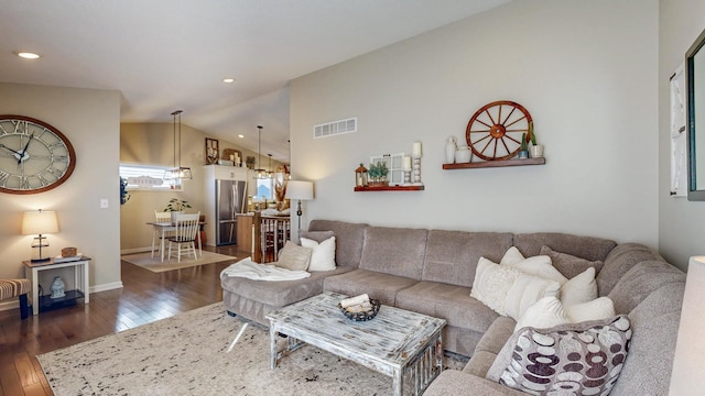 living room with recessed lighting, visible vents, dark wood finished floors, and vaulted ceiling