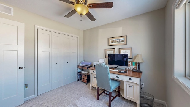 carpeted home office with visible vents, baseboards, and ceiling fan