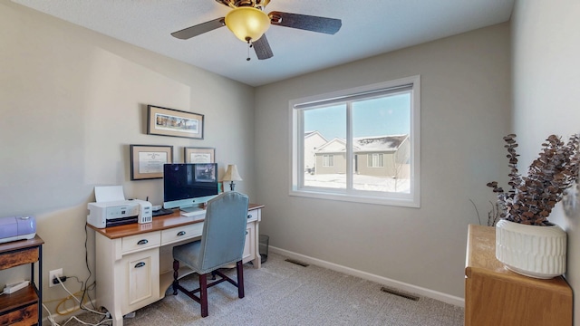 home office with ceiling fan, light colored carpet, visible vents, and baseboards