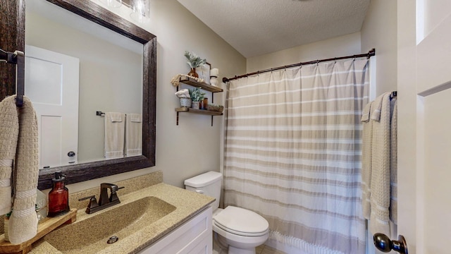 bathroom with vanity, curtained shower, toilet, and a textured ceiling