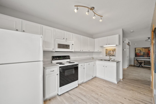 kitchen featuring white cabinets, white appliances, light wood-style flooring, and a sink