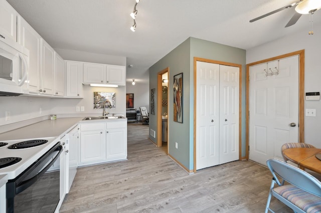 kitchen with a ceiling fan, a sink, range with electric stovetop, light wood-style floors, and white microwave