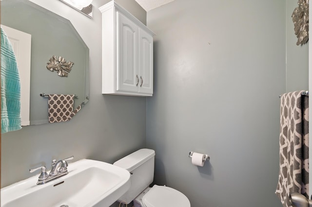 bathroom with toilet and a sink