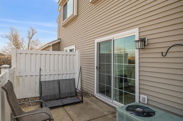 view of patio / terrace featuring cooling unit and fence