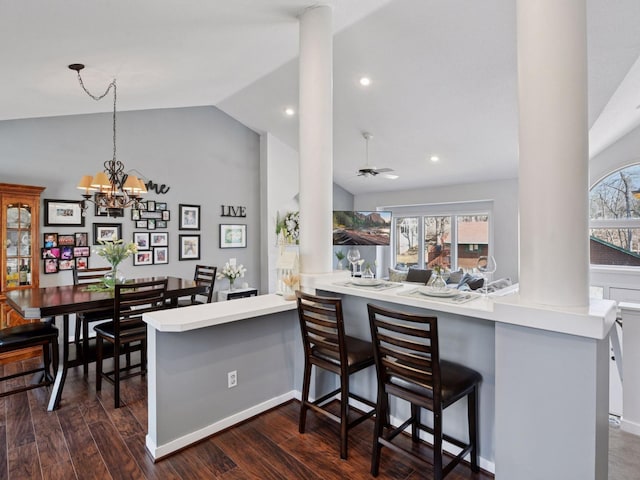3011 Inverness Ln, Mound, MN 55364 - kitchen with ornate columns, vaulted ceiling, pendant lighting, dark wood finished floors, and a peninsula