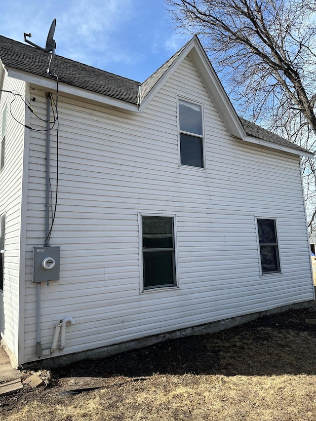 view of property exterior featuring a shingled roof