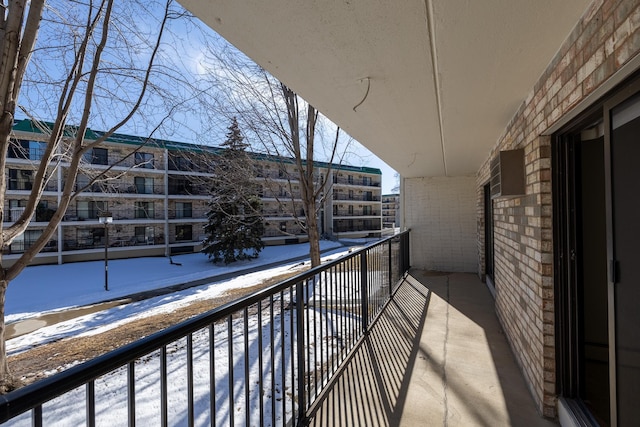 view of snow covered back of property