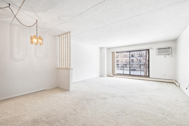 empty room featuring a notable chandelier, a wall mounted AC, a textured ceiling, carpet floors, and baseboard heating