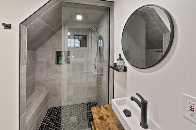 full bath with a sink and a tile shower