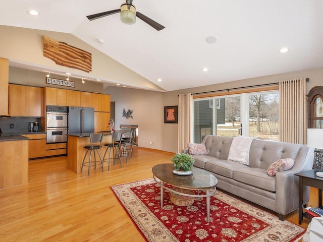 living area featuring light wood-style flooring, recessed lighting, a ceiling fan, and high vaulted ceiling