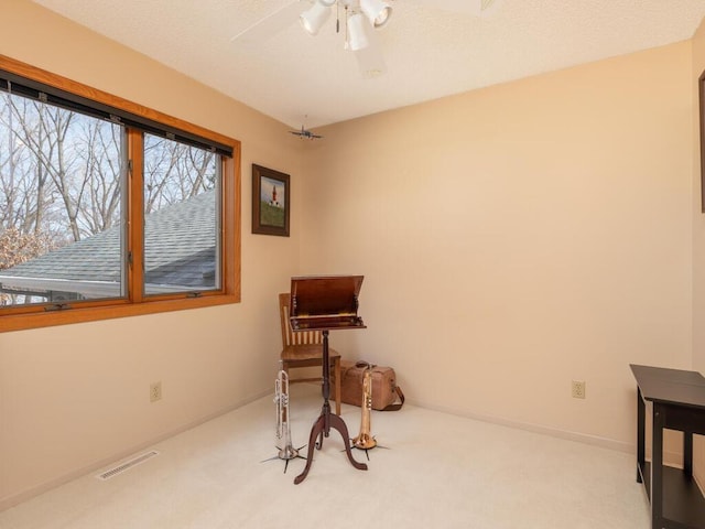 miscellaneous room featuring baseboards, visible vents, carpet floors, and ceiling fan