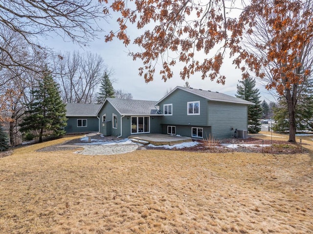 back of property with a patio, central air condition unit, and a yard