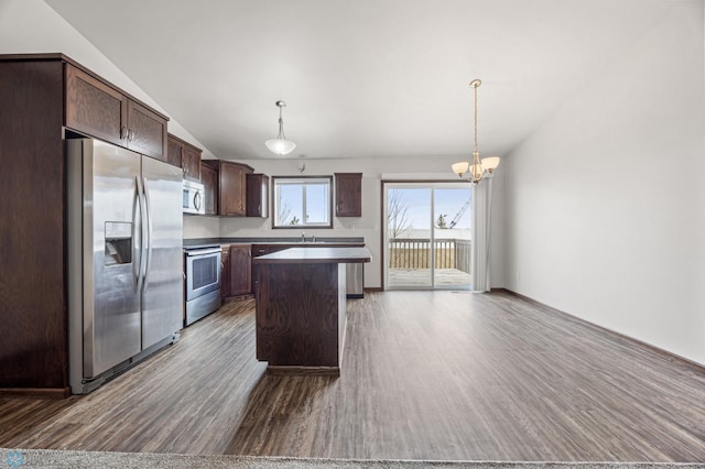 kitchen with a center island, dark wood-type flooring, dark brown cabinetry, vaulted ceiling, and appliances with stainless steel finishes