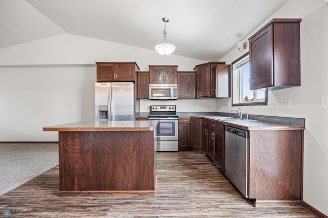 kitchen featuring lofted ceiling, dark brown cabinets, appliances with stainless steel finishes, and a sink