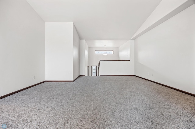 empty room featuring baseboards and carpet flooring