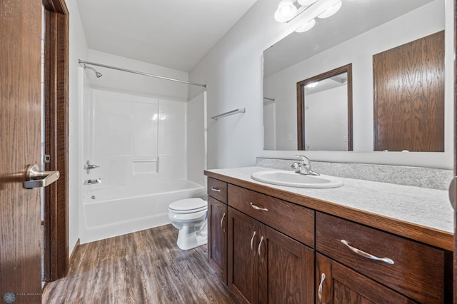 full bathroom with vanity, toilet, wood finished floors, and tub / shower combination