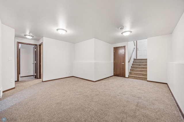 finished basement with carpet flooring, stairs, and baseboards