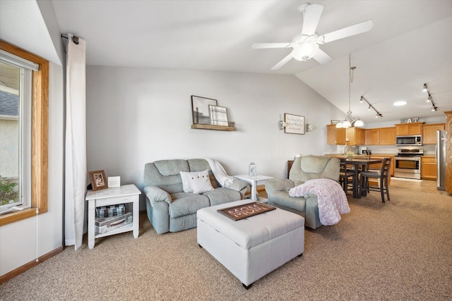 living room with baseboards, ceiling fan, light colored carpet, lofted ceiling, and rail lighting