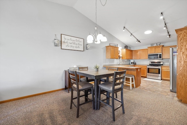 dining space with baseboards, high vaulted ceiling, an inviting chandelier, and rail lighting