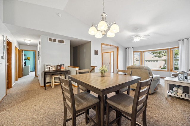 dining area featuring ceiling fan with notable chandelier, vaulted ceiling, light colored carpet, and visible vents