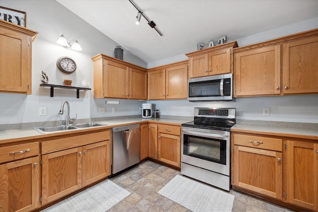 kitchen with a sink, light countertops, lofted ceiling, appliances with stainless steel finishes, and open shelves