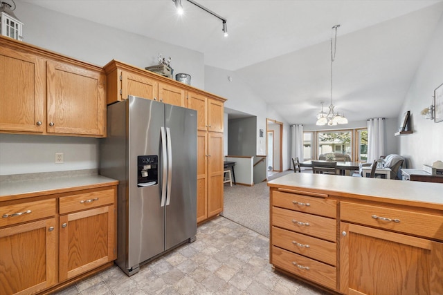 kitchen with stainless steel fridge with ice dispenser, open floor plan, light countertops, lofted ceiling, and a notable chandelier