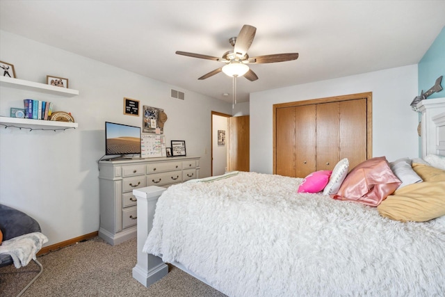 bedroom featuring a ceiling fan, visible vents, baseboards, a closet, and light colored carpet