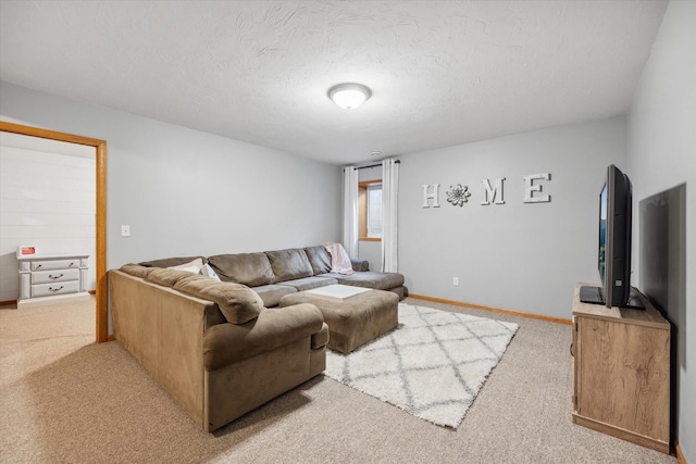 living room with light carpet, baseboards, and a textured ceiling