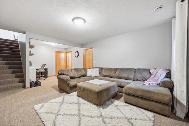 living room featuring baseboards, carpet, stairs, and a textured ceiling