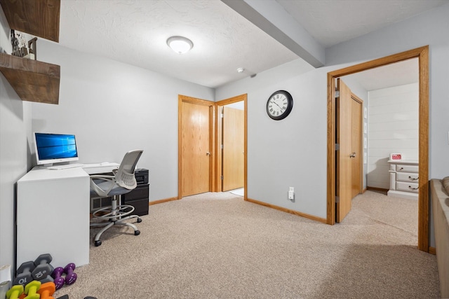 office area featuring light colored carpet, baseboards, and a textured ceiling