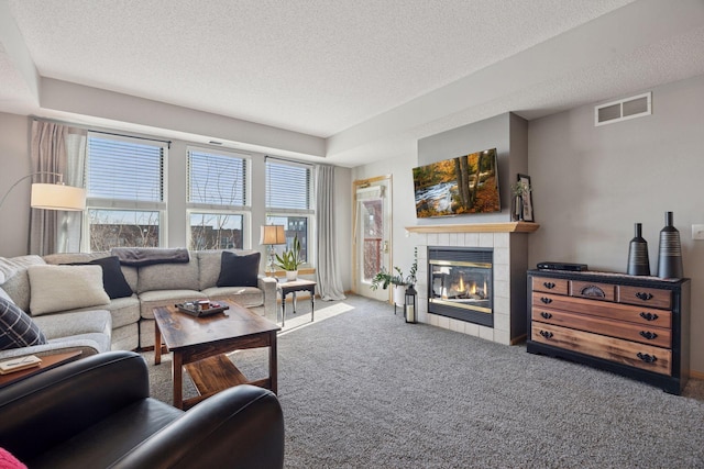 545 1st St Unit 410, Minneapolis, MN 55401 - carpeted living area featuring a fireplace, visible vents, and a textured ceiling