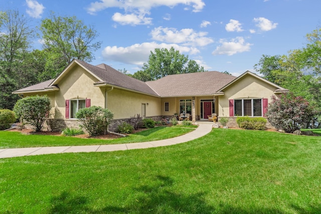 ranch-style home featuring a front yard, stone siding, and stucco siding