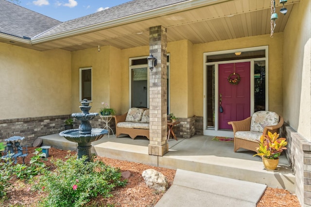 property entrance with covered porch, stucco siding, and a shingled roof