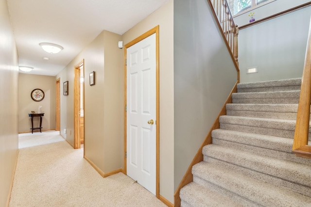 stairway with carpet flooring and baseboards