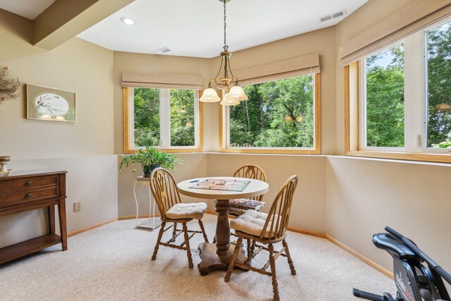 dining room with visible vents, carpet, baseboards, and a chandelier