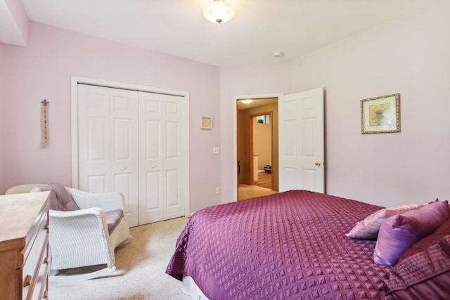 bedroom with a closet and light carpet