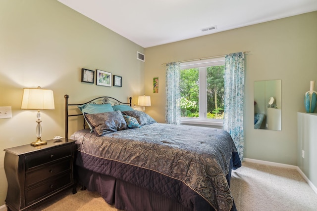 carpeted bedroom with visible vents and baseboards