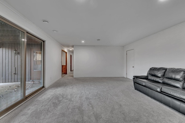 unfurnished living room with carpet and ornamental molding