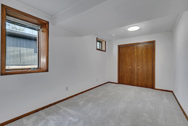 unfurnished bedroom featuring a closet, multiple windows, baseboards, and carpet floors