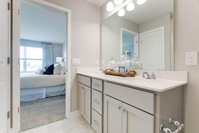 ensuite bathroom with double vanity, ensuite bathroom, and a sink