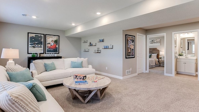 living area featuring light carpet, visible vents, recessed lighting, and baseboards