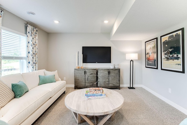 living area with recessed lighting, baseboards, and light carpet