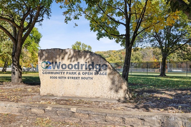 community / neighborhood sign with fence