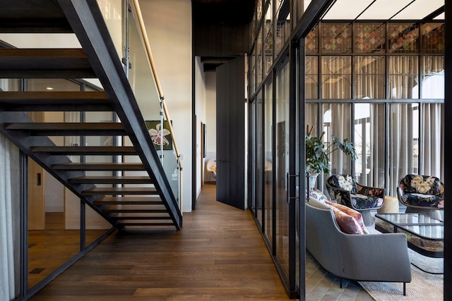 interior space with a wall of windows and wood finished floors