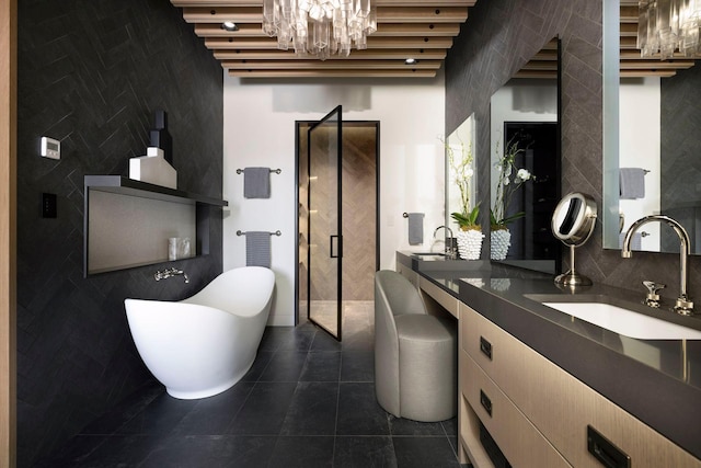 bathroom with a soaking tub, a notable chandelier, tile patterned floors, and a sink