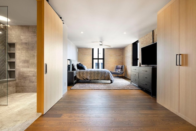 bedroom with recessed lighting and wood finished floors